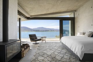 The bedrooms are located within the two upper wings. These spaces present elevated views across the lagoon to the mountains.