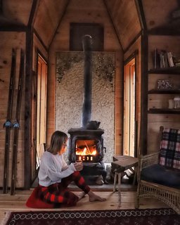 Sara Underwood relaxes by the fireplace in Witzling's fifth cabin.