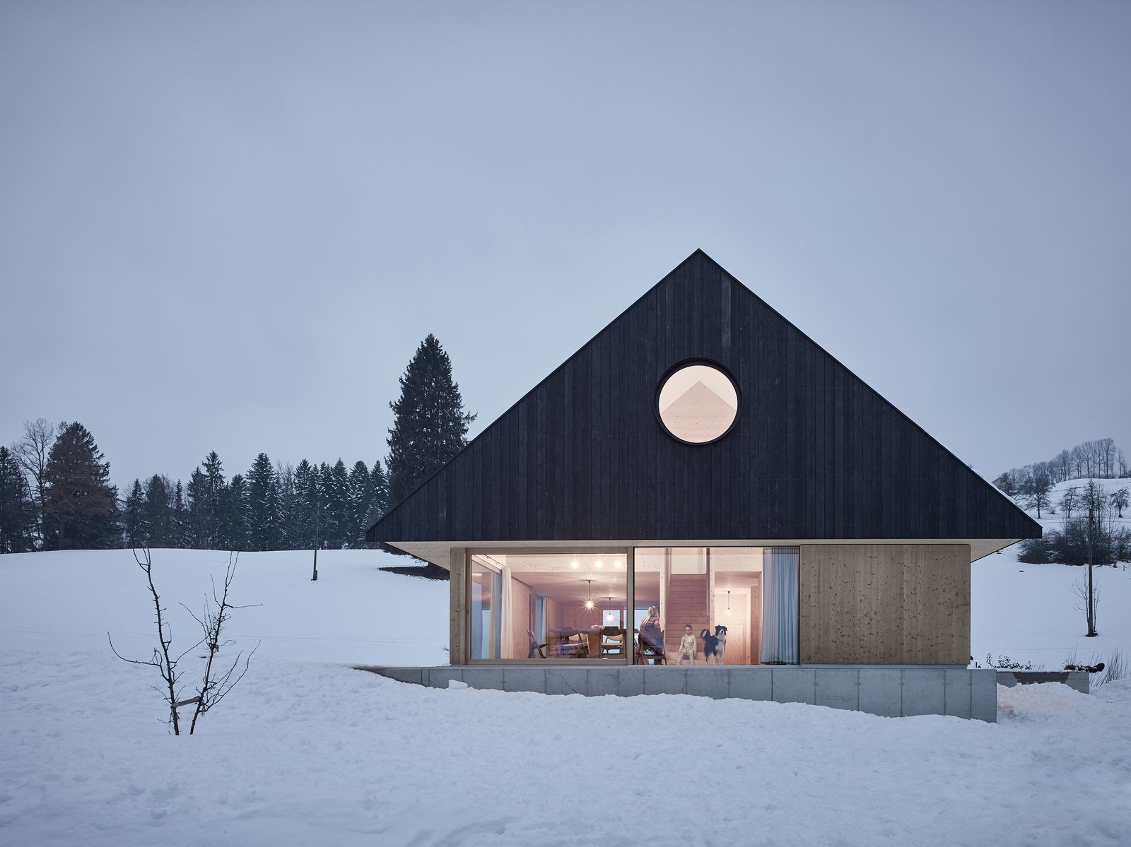Named House With Gable, the 1,680-square-foot home has been beautifully designed by Austria–based studio mia2/ARCHITEKTUR. Constructed predominantly with native timber, a concrete foundation, and expansive glass windows, the modern dwelling also features a massive, eye-catching gable roof.