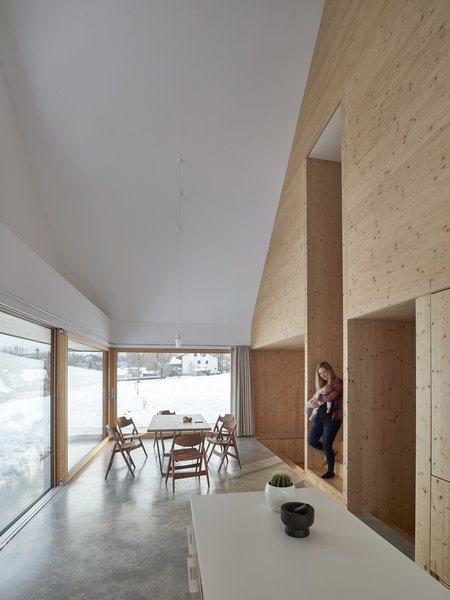 A staircase connects the dining area and kitchen on the ground floor to the bedroom on the upper level.

