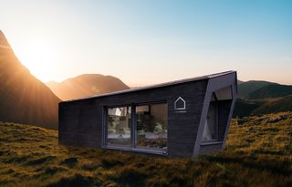 The home's modular design is composed of an outer shell and an interior core unit that contains essential living functions, such as a bed, bathroom, and a small kitchenette.