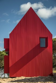 The house has a high-pitched, gabled roof.