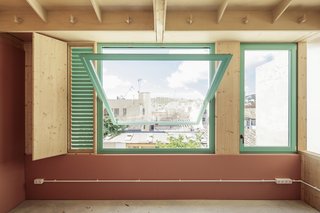 A window on the new upper floor looks out to the city.