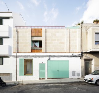 A street view of City House reveals its cheerful, teal accents.