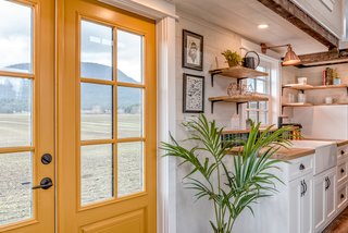 The home boasts a cheery yellow entrance door.