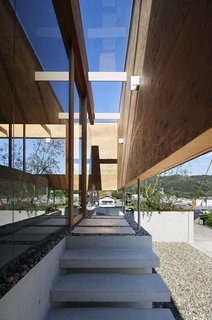 A glass ceiling shelters steps leading to the entrance.