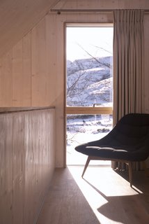 Muted colors and a restrained palette of naturalistic materials combine to create an understated yet confident and beautiful contribution to the hilly landscape.