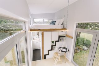 The loft bedroom is located above the bathroom/laundry area.