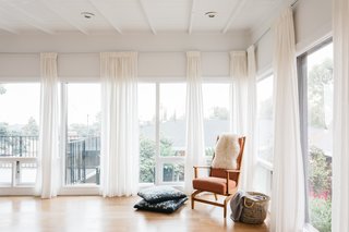 Floor-to-ceiling windows bring plenty of light into the master bedroom.