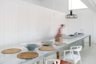 The dining area is an extension of the aluminum kitchen.