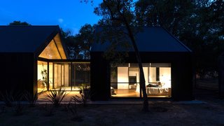 Interior furnishings are minimal to highlight the greenery outdoors.