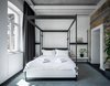 Modern home with Bedroom, Wall Lighting, and Bed. Exposed ceiling pipes give this bright bedroom a cool, industrial aesthetic. Photo 11 of BURSA Hotel