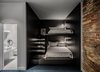 Modern home with Bedroom, Bed, and Wall Lighting. "Our conceptual approach was that of an ‘adaptive reuse,’ allowing the building to preserve its historic integrity and aesthetics while providing for the needs of modern occupants," says Balbek. Photo 12 of BURSA Hotel