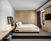 Modern home with Bedroom, Table Lighting, and Bed. This guest suite features whitewashed brick walls. Photo 13 of BURSA Hotel