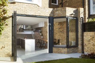 The kitchen door opens wide to improve connectivity to the backyard.