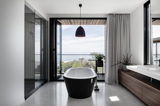 A Kado Lure freestanding tub in the bathroom provides opportunity for an luxurious soak.