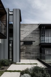 Because it angles off the suburban grid, the house is able to stretch from east to west across the site so every room enjoys optimal passive solar gain.