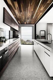 Concrete countertops by Newform Concreting lead the eye towards a large picture window.