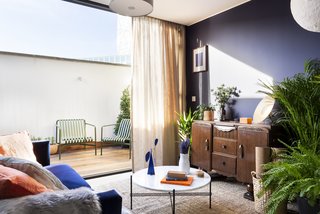 The living room in the penthouse opens to a sunlit terrace.