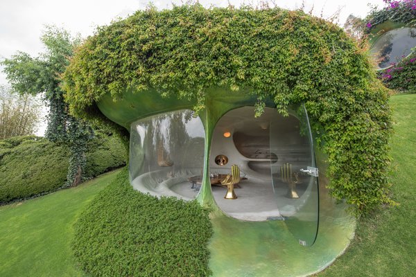 Architect Javier Senosiain created this remarkable home on a hilly site near Mexico City. "The green dune wraps itself around the inside spaces almost completely, rendering it almost invisible so that, from the outside, all one sees are grass, bushes, trees, and flowers," he says.