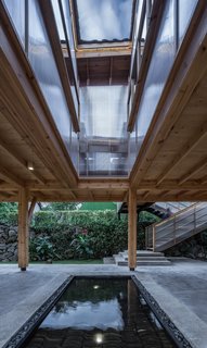 From the library, users can look down at the pond through the clear panels. "The setting of the patio looks like it is waiting for a certain time—for the sun to cast in a beautiful shadow, for the rain to drip ripples, or for the breeze to blow in," says lead architect Liu Dongying.