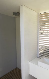 The rainfall shower head is from a range at Victoria Plumb, while the compost toilet in stainless steel is from Natsol.