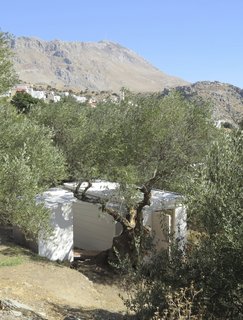 The exterior of the house is clad in white composite with an etched surface pattern. 