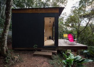 An Indusparquet wood deck extends into the forest.