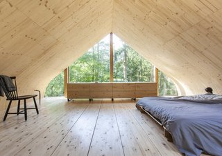 A pitched-roof bedroom enjoys glazed walls to the north and south.