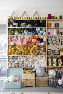 Shelves of yarn in Erin's workspace.