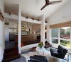 Modern home with Kitchen, Engineered Quartz Counter, Dark Hardwood Floor, Refrigerator, Range Hood, White Cabinet, Glass Tile Backsplashe, and Recessed Lighting. View to the kitchen and living room beyond Photo 3 of Healdsburg Makeover