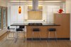 Modern home with Kitchen, Engineered Quartz Counter, Wood Cabinet, White Cabinet, Refrigerator, Medium Hardwood Floor, and Ceiling Lighting. A kitchen designed to be backdrop to the great room Photo of Sonoma Modern Kitchen
