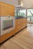 Modern home with Kitchen, Engineered Quartz Counter, Medium Hardwood Floor, Wood Cabinet, Ceiling Lighting, and Wall Oven. Kitchen oven hidden from view Photo 2 of Sonoma Modern Kitchen