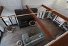 Modern home with Front Yard, Gardens, Wire Fences, Wall, Closet Storage Type, Large Patio, Porch, Deck, Metal Patio, Porch, Deck, Wood Patio, Porch, Deck, Under Stairs Storage Type, Wood Tread, Metal Railing, and Living Room. View to the Living Room from the Loft Photo 8 of Modern Vineyard Farmhouse