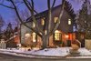 The exterior features Maibec wood siding, a Mahogany door and black framed windows. Photo of Manor Road house modern home