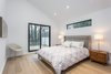 The master bedroom on the second floor with a walk out deck, overlooking the private backyard. Photo 8 of Manor Road house modern home
