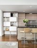 Modern home with Laminate Cabinet, Medium Hardwood Floor, Ceiling Lighting, Engineered Quartz Counter, Recessed Lighting, and Storage Room. Modular Storage - custom wood laminate storage unit in Italian wood laminate to match kitchen cabinetry designed in collaboration with Sozo Studio. Italian stools from DWR. Madeline Weinrib custom wool and silk rug from Nepal. Walls in Benjamin Moore Color of the Year 2016 Simply White OC-117. Photo 3 of Arden Mission Bay Contemporary Condo