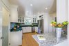Modern home with Kitchen, Granite Counter, White Cabinet, Ceiling Lighting, Refrigerator, Recessed Lighting, Glass Tile Backsplashe, Undermount Sink, Dishwasher, Medium Hardwood Floor, Range, Range Hood, and Cooktops. White Farmhouse Kitchen Remodel Photo of White Farmhouse Kitchen Remodel