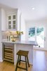 Modern home with Kitchen, White Cabinet, Glass Tile Backsplashe, Light Hardwood Floor, Ceiling Lighting, Granite Counter, Wine Cooler, Recessed Lighting, and Beverage Center. White Farmhouse Kitchen Remdodel Photo 5 of White Farmhouse Kitchen Remodel