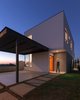 Guided by the precept of "less is more," the project was developed by valuing the straight lines, pure volumes contrasted in the landscape. Photo 8 of SG House modern home