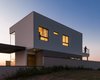 The volumetry is imposing in the landscape,the volumes overlapping, are like two prisms, white and gray. The darker color on the bottom gives the feeling that the upper volume rests on the bottom, making the scenario lighter. Photo 7 of SG House modern home