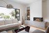 Modern home with Living Room, Sofa, Light Hardwood Floor, Coffee Tables, Corner Fireplace, Floor Lighting, and Gas Burning Fireplace. Living room Photo 6 of 27th Street - Noe Valley