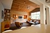 Modern home with Living Room, Bench, Chair, Sofa, Sectional, Recliner, Ottomans, Track Lighting, Bookcase, Ceiling Lighting, Floor Lighting, Table Lighting, and Carpet Floor. Den - view from kitchen Photo of Alamo