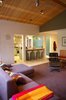 Modern home with Living Room, Ottomans, Chair, Sectional, Recliner, Track Lighting, Carpet Floor, and Terrazzo Floor. View towards kitchen Photo 11 of Alamo