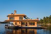 Modern home with Exterior, House Building Type, Metal Roof Material, and Wood Siding Material. When avid outdoorsman Richard Daigneault set out to create the ultimate, compact houseboat, his masterful woodworking skills and eco-friendly ethos produced a floating home so coveted that he launched a company to meet demand for his amphibious dwelling—with a starting price of $79,000 CAD (approximately $61,000 USD). Photo 14 of The Barge Yacht