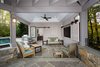 Sun bathers can escape the heat while dining on the flagstone patio under the ceiling fan or warm up while the gas fire pit is operating. see the full case study, http://www.markivbuilders.com/outdoor-kitchen-bethesda-maryland/ Photo 9 of Outdoor Kitchen and Patio modern home