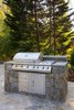 This deluxe professional grill provides amble power to cook for a large group. It includes a side burner, four burners, and storage. Photo 4 of Outdoor Kitchen and Patio modern home