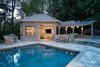 Built from western red cedar, this outdoor kitchen and pergola features V-groove siding set in a horizontal pattern. A folding window is set into the building's front for easy access. Photo 5 of Outdoor Kitchen and Patio modern home