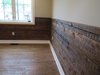 Modern home with Living Room and Medium Hardwood Floor. Wooden boards preserved from the original structure were installed as a decorative feature. Photo 9 of Commercial Garage Converted