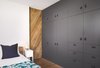 Full height closet storage cabinets and post oak pocket door. Photo 16 of Airole Way Residence modern home